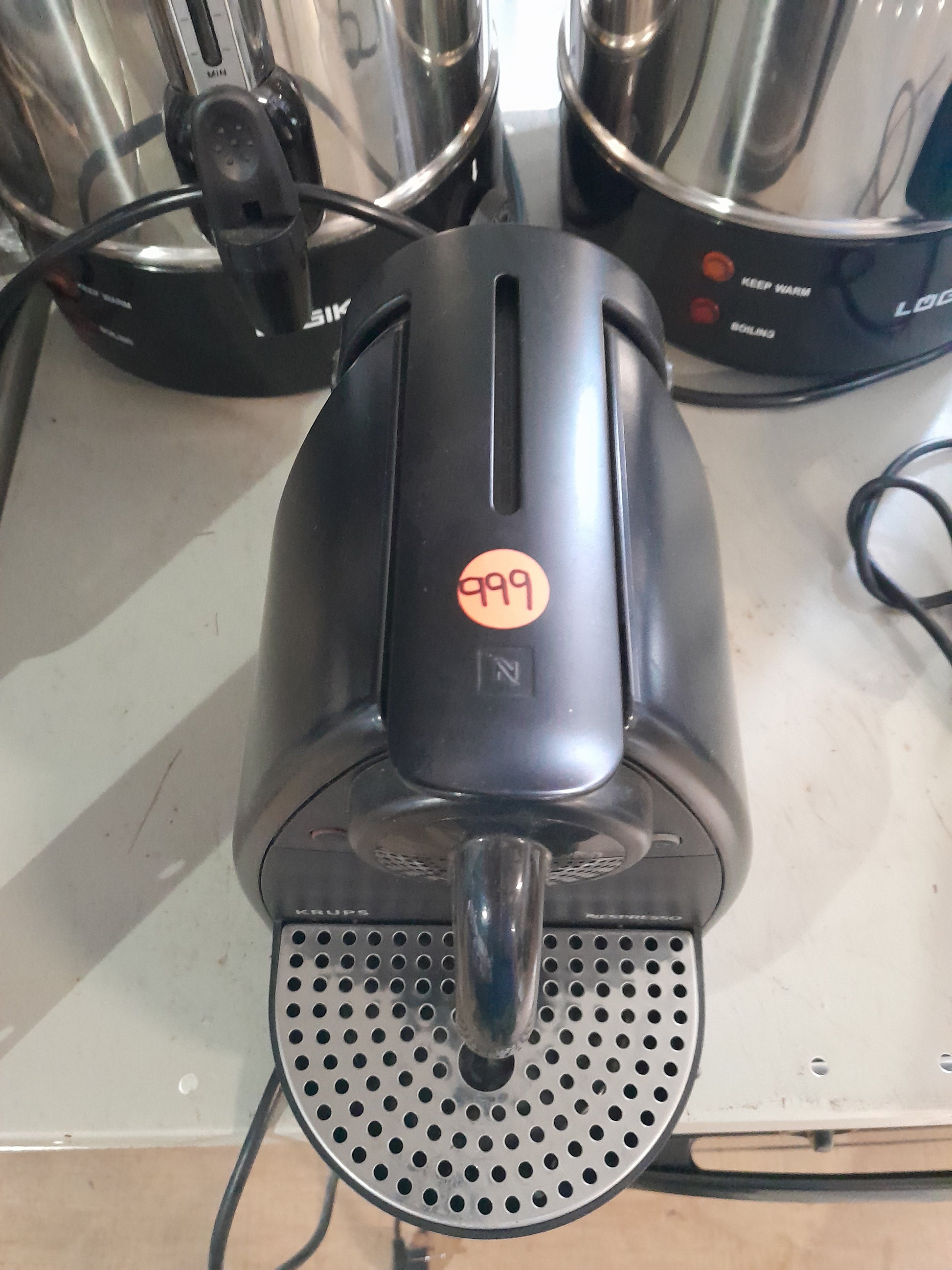 Krups Nespresso capsule coffee maker, a stylish and compact appliance for quick espresso preparation.