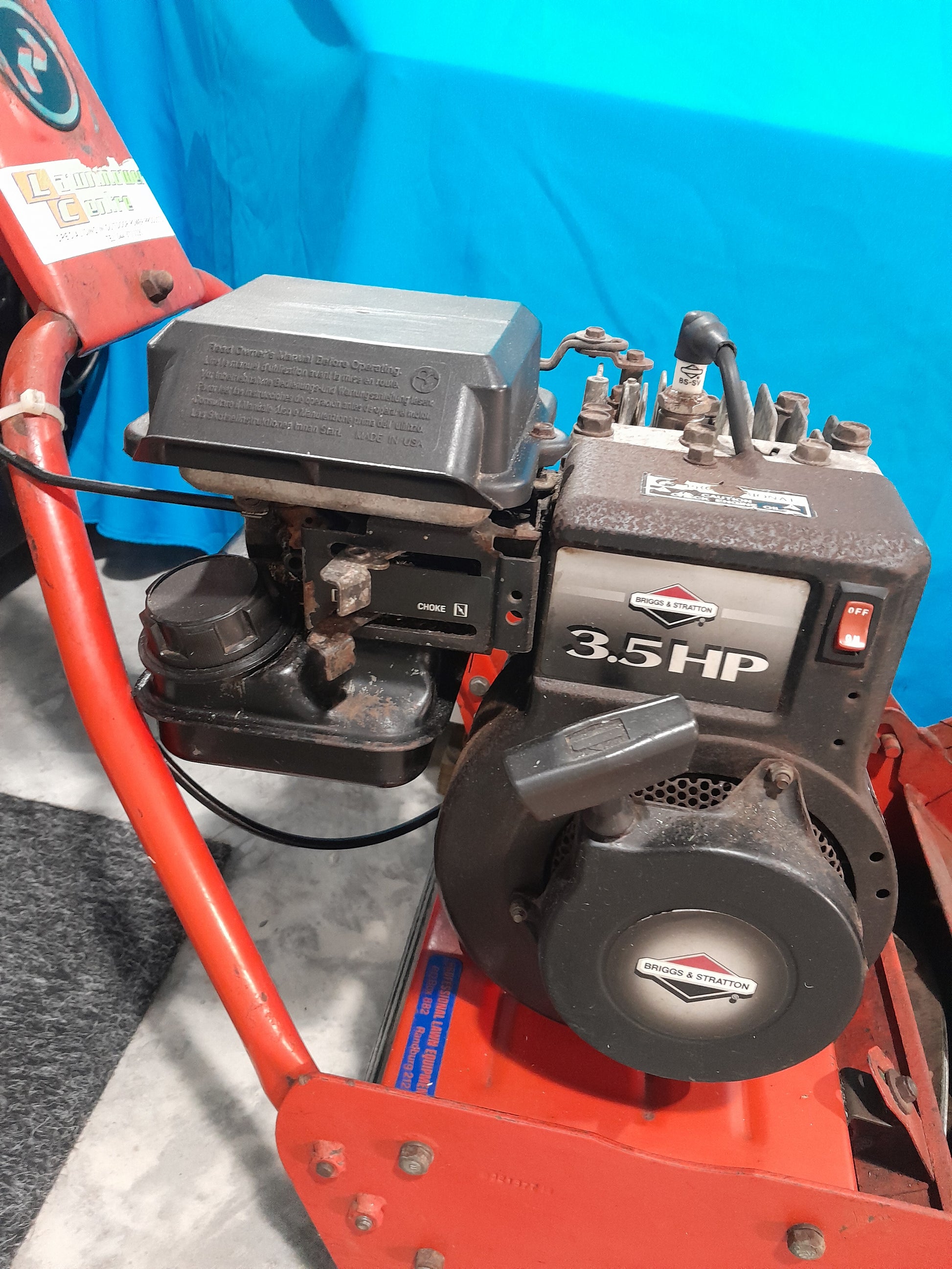 Professional rolling lawnmower with 3.5HP Briggs and Stratton engine for efficient lawn care.