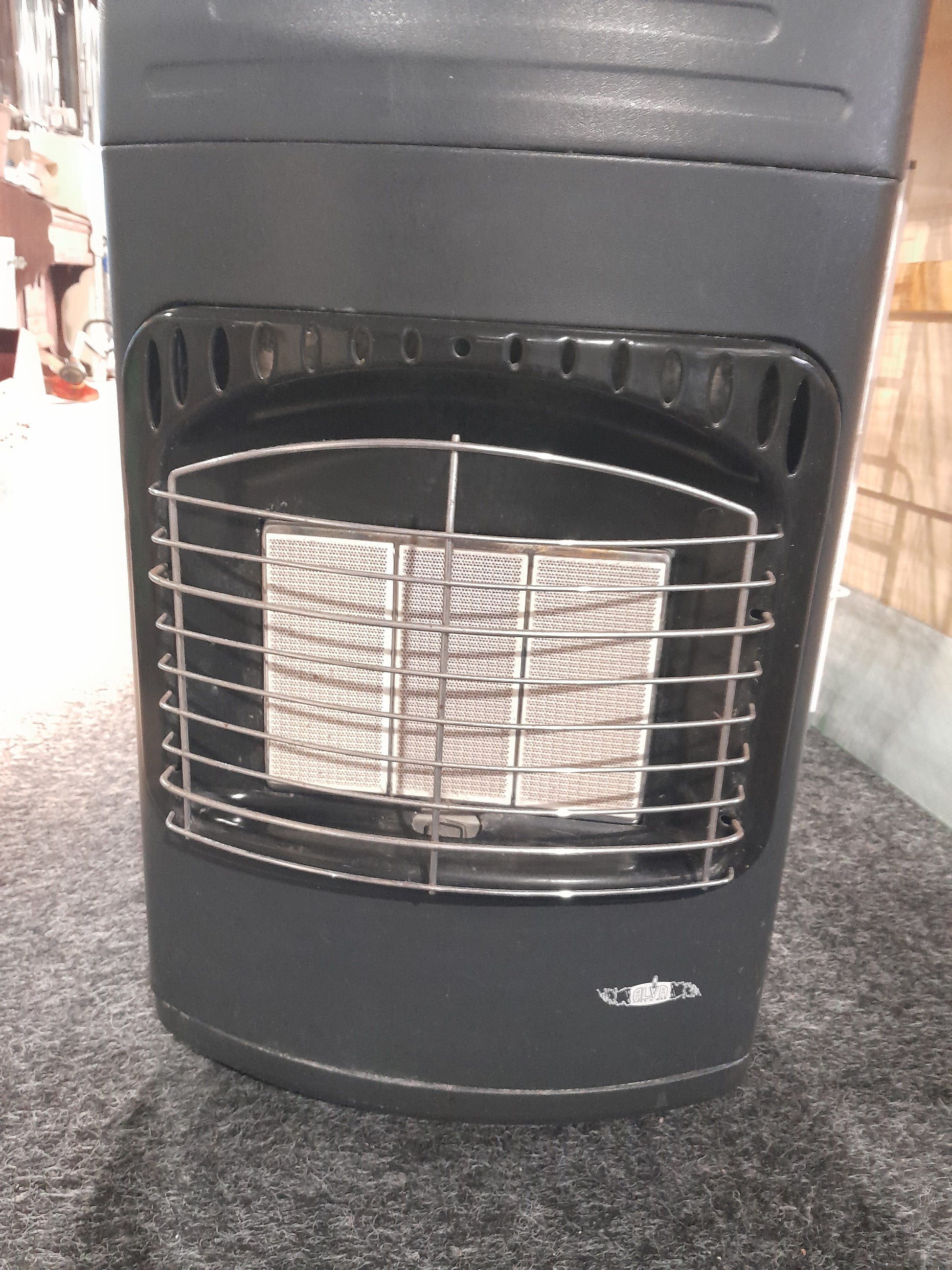 ALVA 3 Panel Gas Heater displayed in a secondhand store, perfect for cozy indoor warmth.