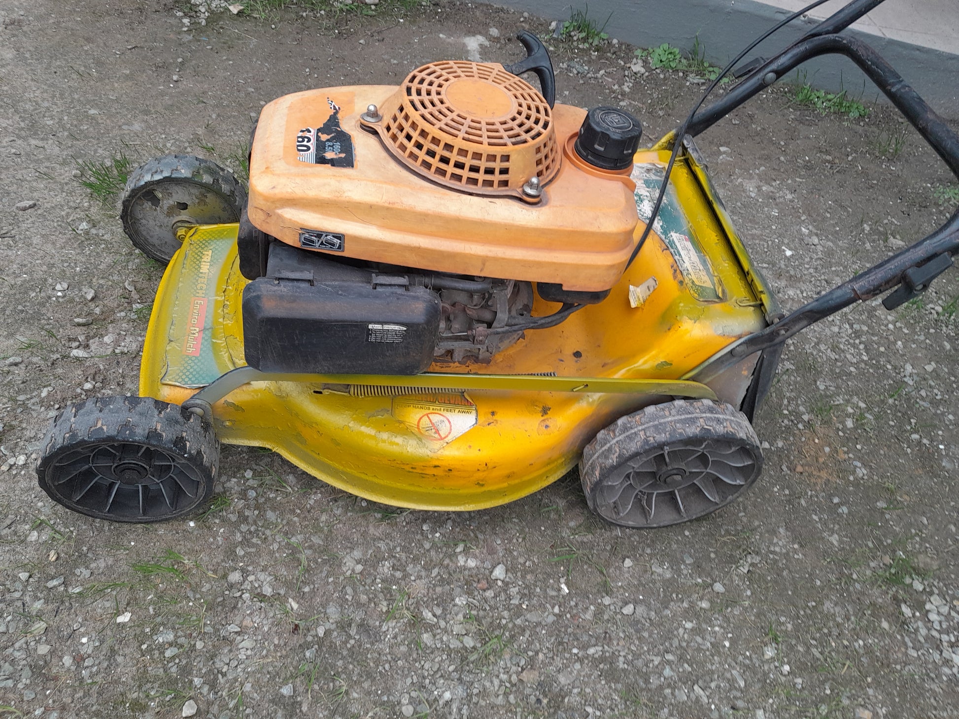 Used Trimtech XT 160 petrol lawnmower for sale in good condition, ideal for garden maintenance.