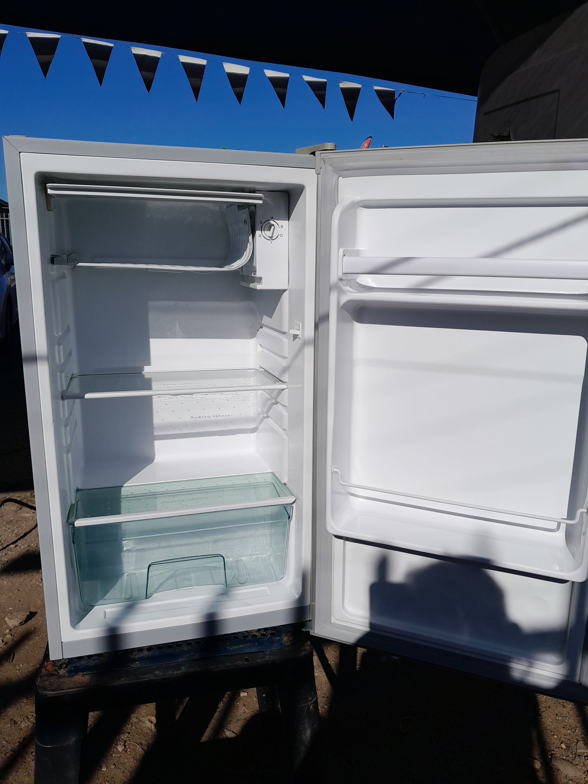 Clear glass shelves inside the Salton bar fridge, designed for easy organization.