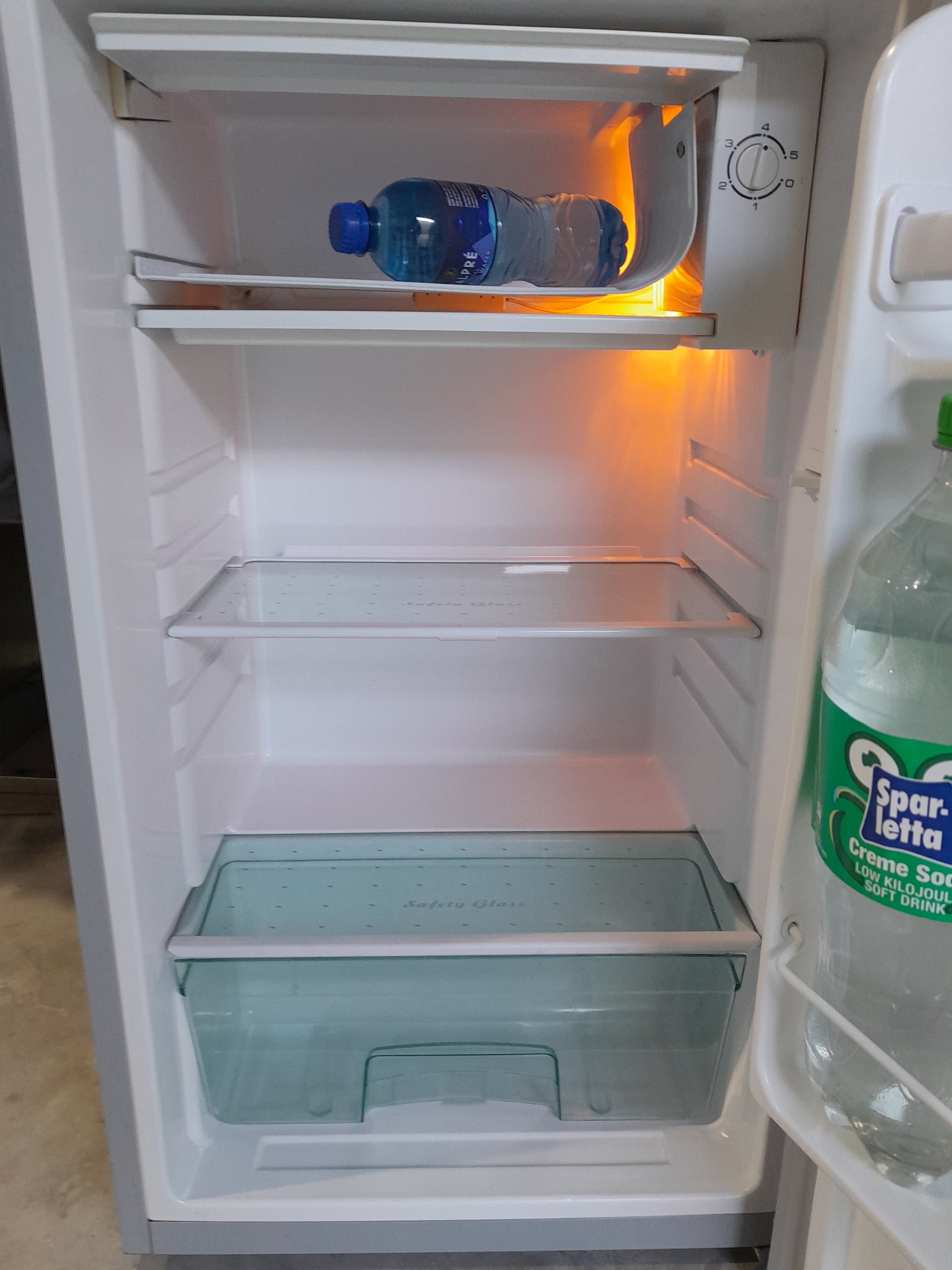 Open Salton bar fridge displaying spacious interior and glass shelves for beverages.