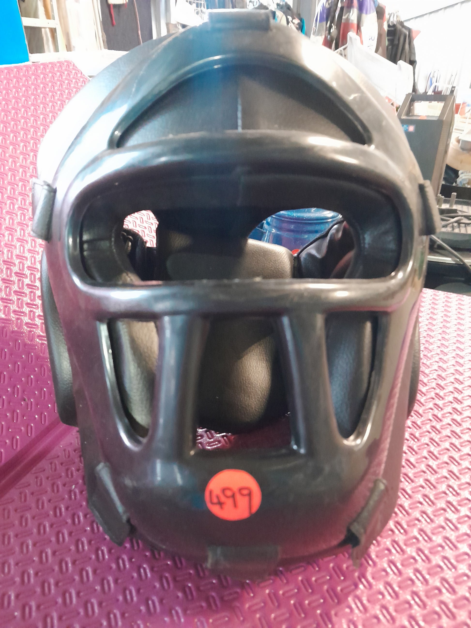 Protective headgear for MMA and boxing, crafted from durable leather for safety during sparring.