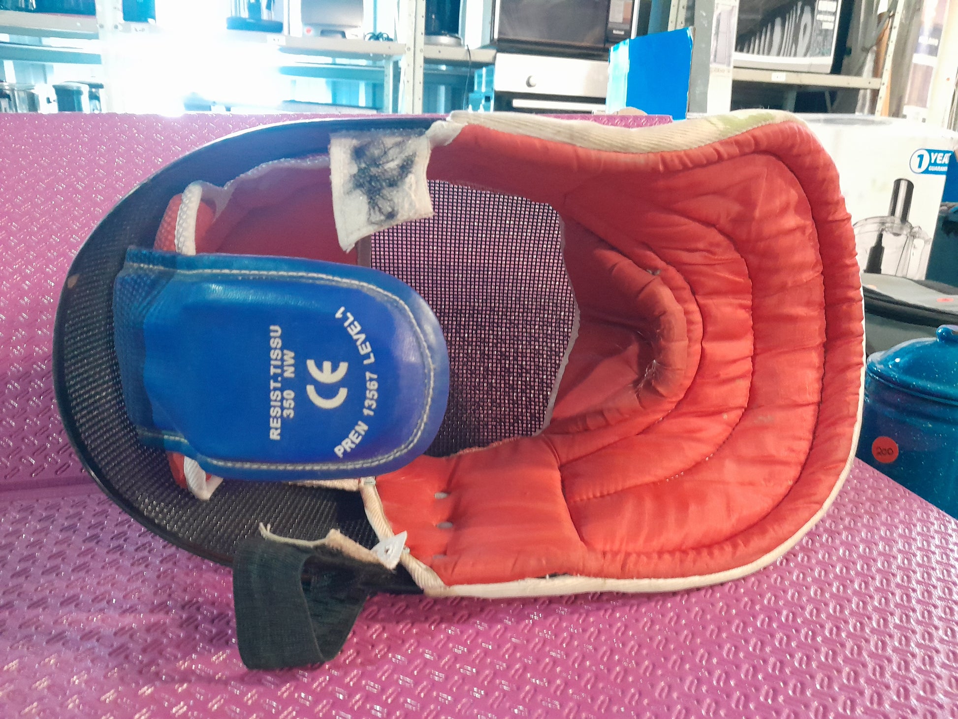 Fencing mask with a strong mesh design and neck bib, ensuring safety during fencing bouts.