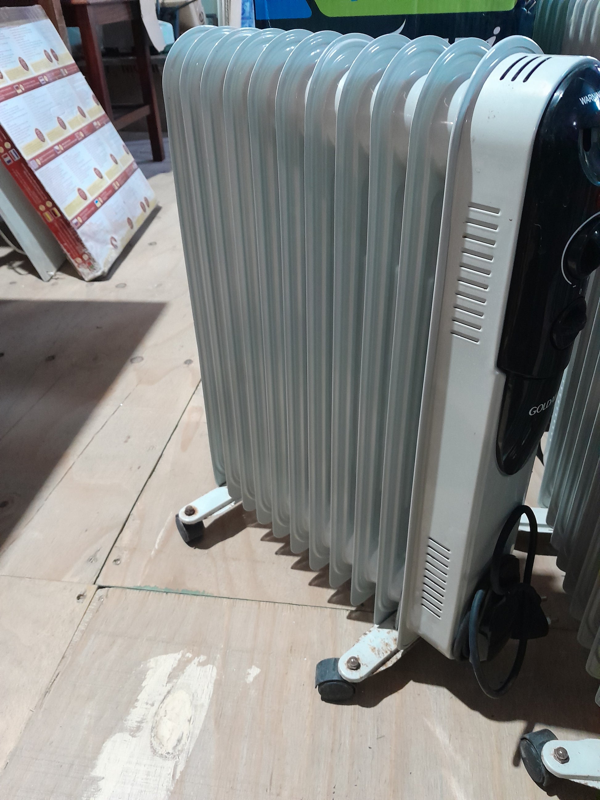 Goldair 11Fin Slim Oil Heater, portable room heater with wheels, ideal for quick heating.